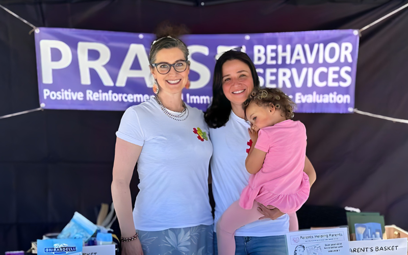 2 women and child and promotion booth