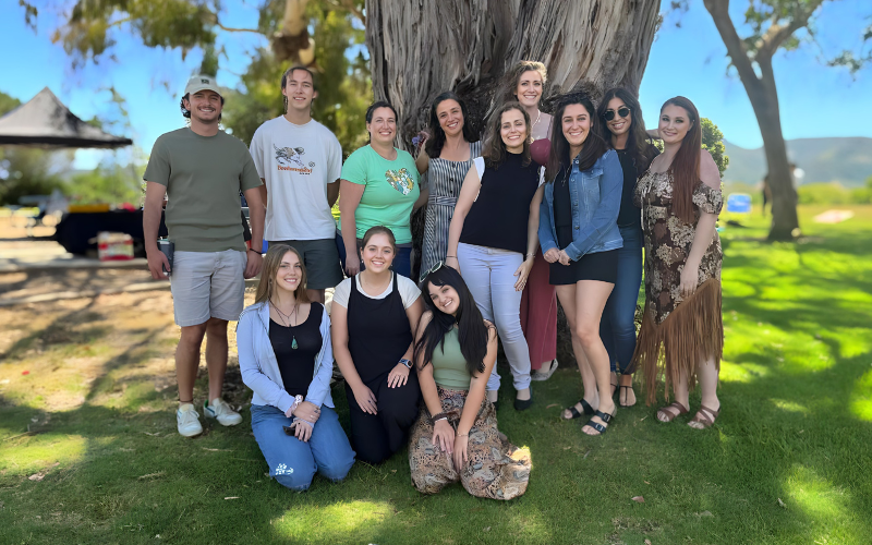 group of people in front of a tree